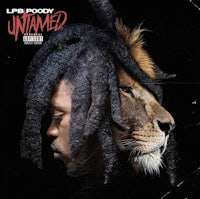 a man with dreadlocks and a lion on his head