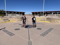 two men standing in front of a circular walkway