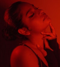 a woman posing with her hand on her chin