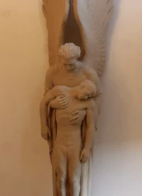 a statue of an angel holding a man
