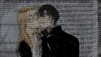 a man and a woman kissing in front of a black background