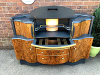 a wooden cabinet with a glass top and drawers