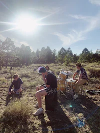 a group of people playing drums in a field