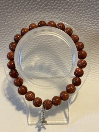 a brown beaded bracelet on a clear surface