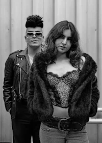 a black and white photo of a man and woman posing