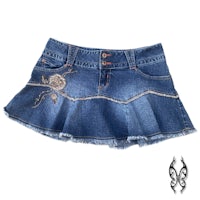 a blue denim skirt with a flower embroidered on it