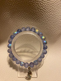 a bracelet with a blue glass bead on it