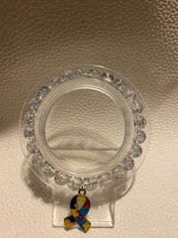 a clear crystal ring with a charm on it