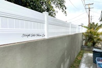 a white fence with graffiti on it
