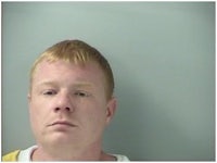 a mug shot of a man with red hair
