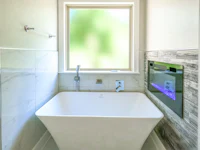 a bathroom with a white tub and a window