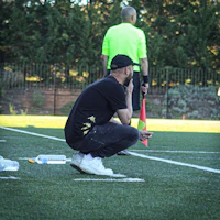 a man crouching down on a soccer field