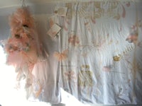 a pink and white curtain hanging in a room