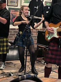a group of people in kilts playing music