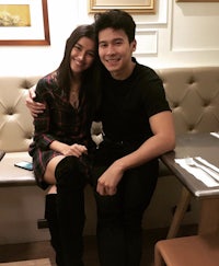 a man and woman posing for a picture in a restaurant