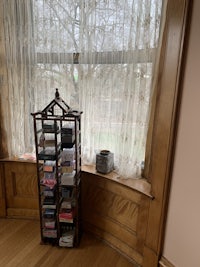 a book shelf in a room with a window