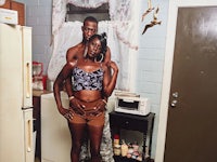 a man and woman posing in front of a refrigerator