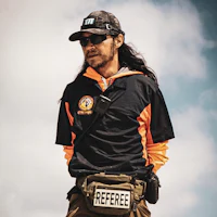 a man wearing a hat and a fanny pack