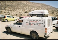 a white van parked in a dirt lot