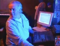 a man sitting in front of a computer in a dark room