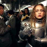 a woman dressed as a knight on a subway