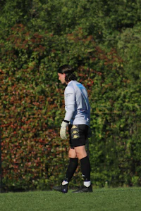 a soccer player is catching a ball