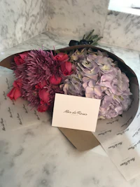 a bouquet of flowers sitting on a marble table