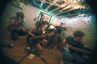 a group of people playing guitars in a room
