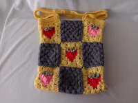 a crocheted bag with strawberries on it