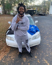 a man standing next to a white car
