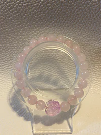 a bracelet with a pink stone on it