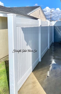 a white fence in the backyard of a house