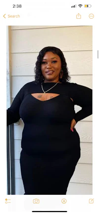 a woman is posing for a picture in a black dress
