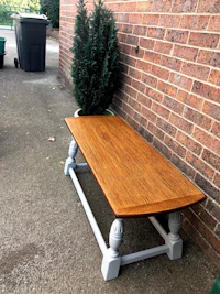 a wooden coffee table in front of a brick wall