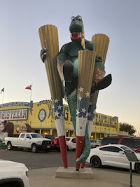 a statue of a man holding a pair of ski poles