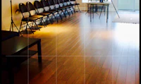a room with chairs and a wooden floor