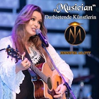 a woman holding an acoustic guitar in front of a microphone