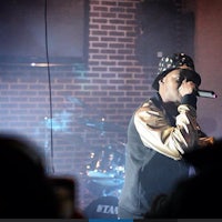 a man in a hat singing into a microphone