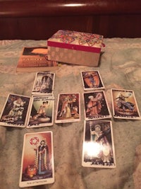 tarot cards and a box on a bed