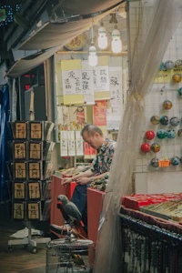 a man sits at a table in front of a shop
