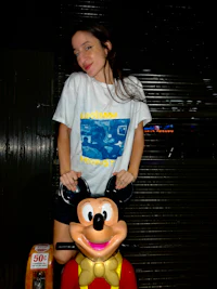 a woman wearing a mickey mouse t - shirt