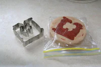 a cookie cutter next to a bag of cookies