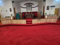 a church with a red carpet and a cross