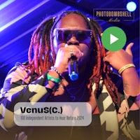 a man with dreadlocks is singing into a microphone