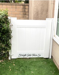 a white gate in front of a house