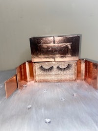 a pair of false eyelashes in a box on a white surface