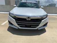 the front end of a white honda accord