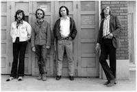 a group of men standing in front of a door