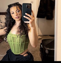 a woman taking a selfie in a green top