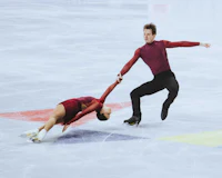 a pair of figure skaters performing on the ice